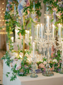 crystal chandeliers and floral arch reception décor