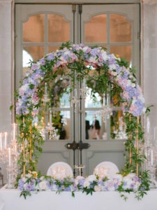 sweetheart table with floral arch