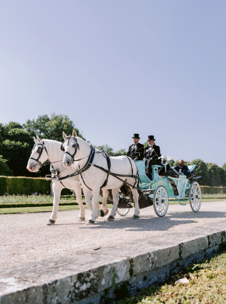 Horse-drawn carriage arrival at luxury château wedding
